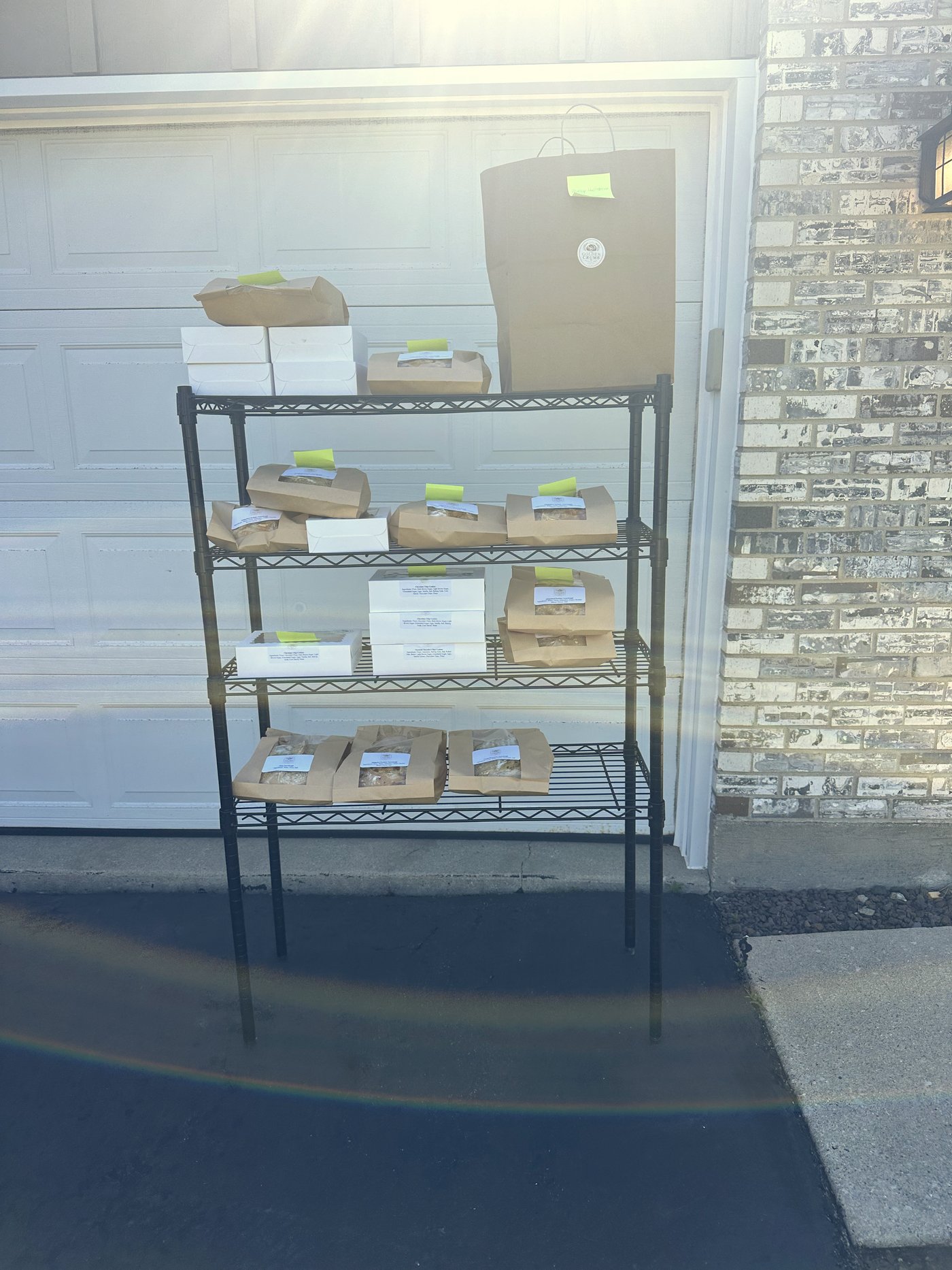 The pickup rack stocked with bread bags and white cookie boxes for the June bake